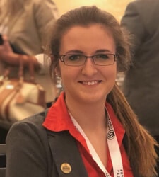 a woman wearing glasses and smiling at the camera a woman wearing glasses and smiling at the camera