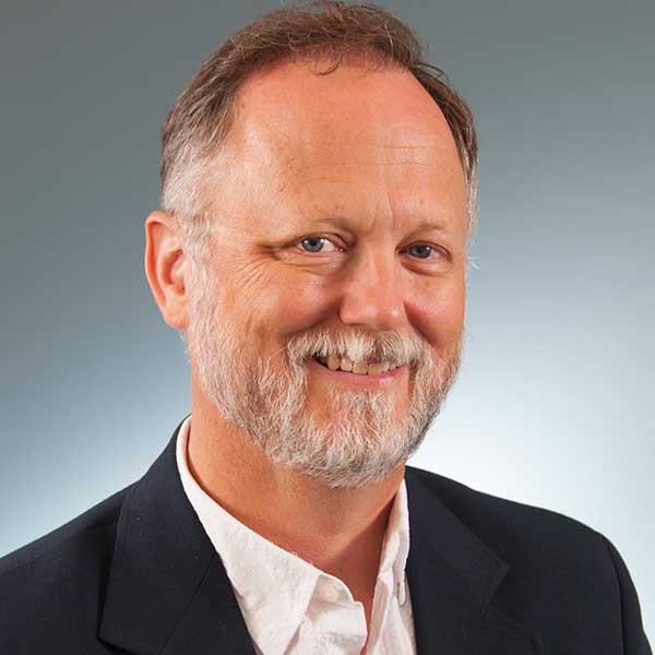 Paul Hard wearing a suit and tie