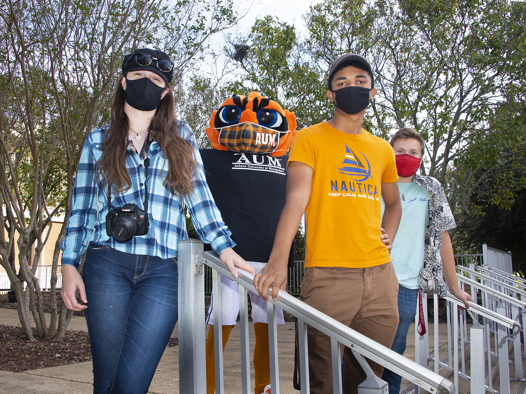 a group of people standing next to a fence