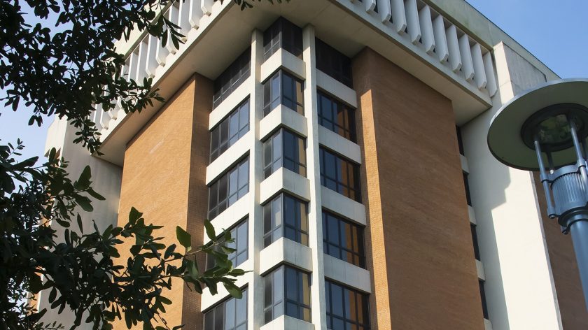 A Large Tall Tower With A Clock On The Side Of A Building