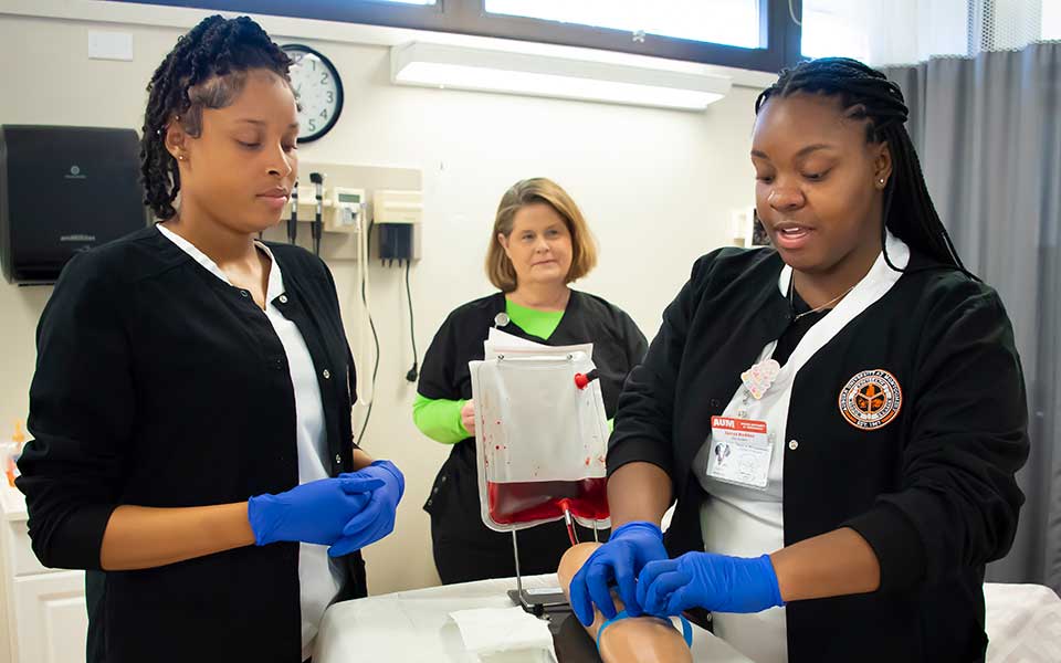 Nursing students training on an IV