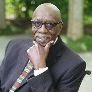 A Man Wearing A Suit And Tie Talking On A Cell Phone