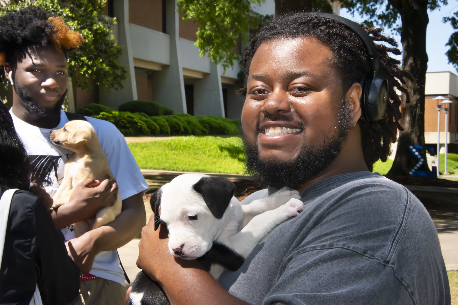 a man and a woman holding a dog