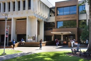 Students walk around the Quad in front of the College of Business.