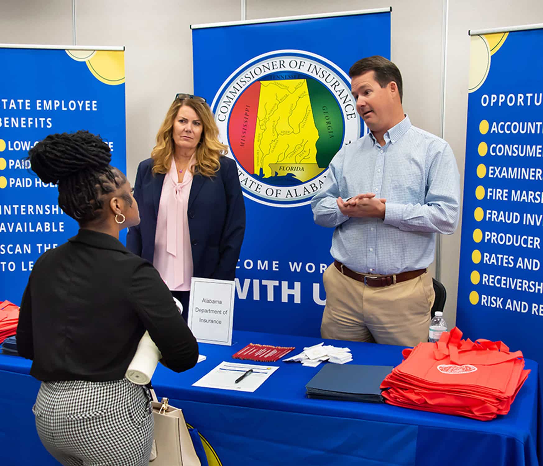 a group of people standing in front of a sign