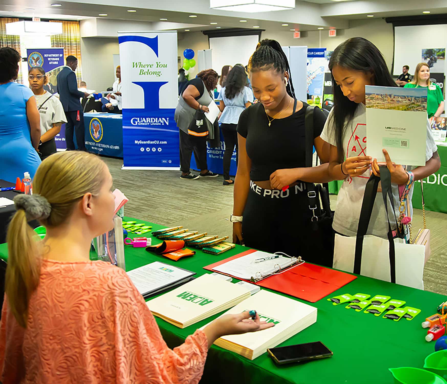 a group of people standing around a table