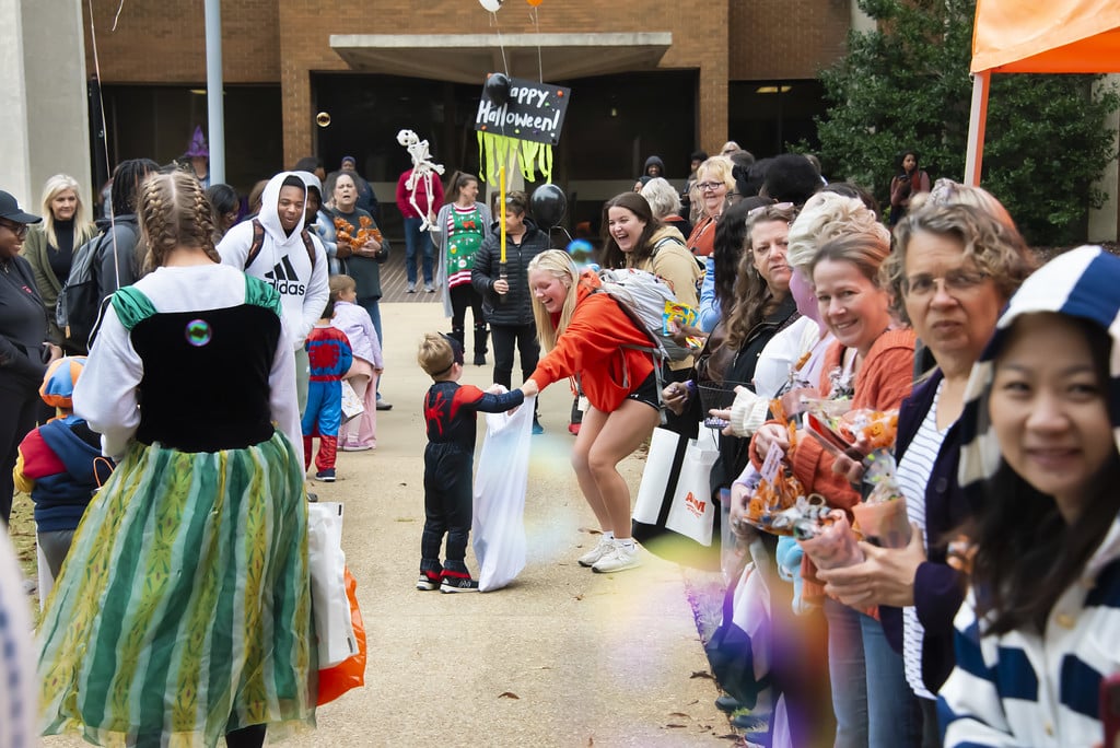 Students, faculty, and staff line the sidewalks to hand out candy and treats to ELC Trick-or-Treaters.