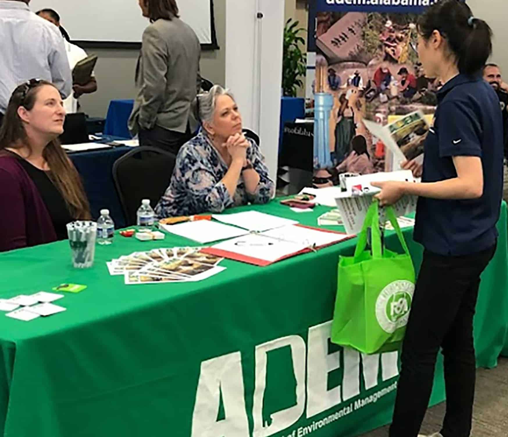 Students visit the ADEM table at a Career Fair.