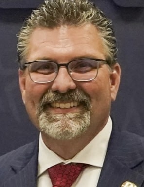 a man wearing glasses and a suit and tie