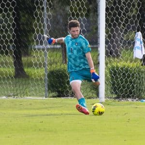 Goalkeeper, Alfie Rule, kicks the ball back into play.