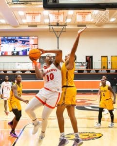 Men's Basketball jumps for a two-pointer against Miles College.
