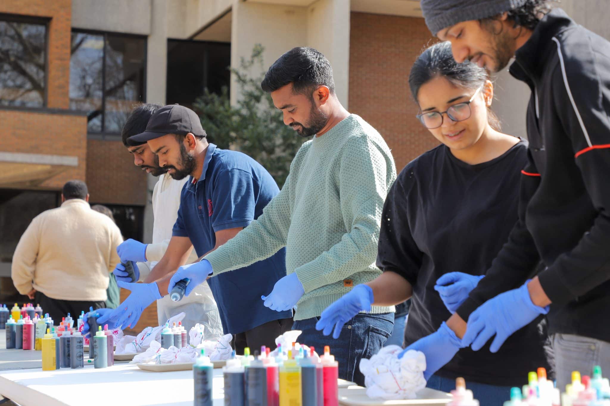 Students tie-dyed t-shirts on The Quad as part of Homecoming Week.