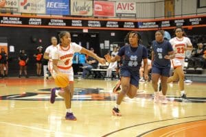 Allasha Dudley dribbles the ball down court.