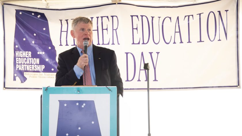 Gordon Stone Speaks At Higher Education Day In Alabama In 2024. Stone, Seen Speaking At The Podium And Wearing A Navy Jacket, Blue Dress Shirt And Orange Tie, Will Serve As Auburn University At Montgomery's Spring 2025 Commencement Speaker.