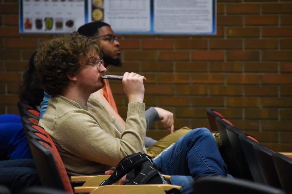 Students Watch Fellow Presenters At The College Of Sciences Student Research Symposium.