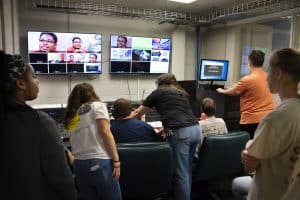 AUM Communication professors teach students how to use the camera switcher for a news broadcast.