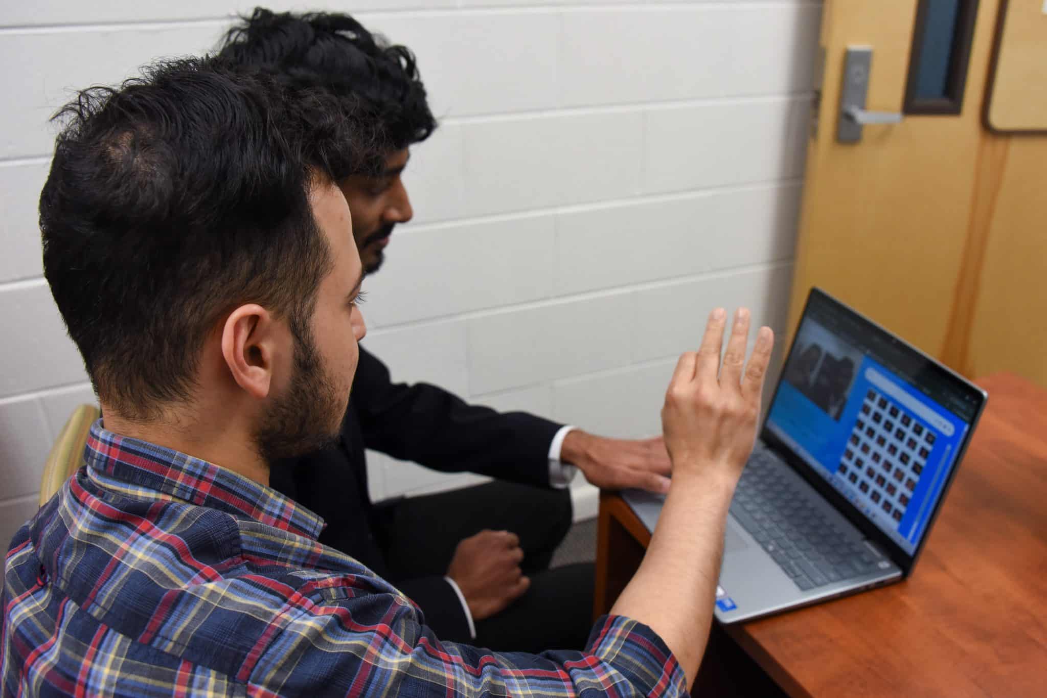 Grad student, Harshavardhan Meka, and professor Tathagata Bhattacharya work on training sign language into their AI recognition software.