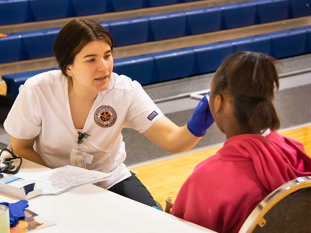 AUM Nursing student administering a test.