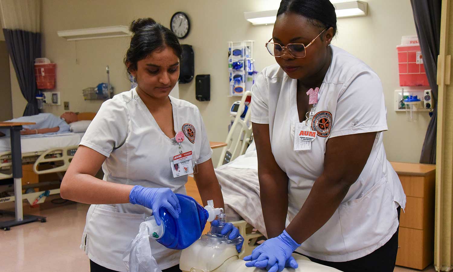 nursing students performing CPR on a test dummy