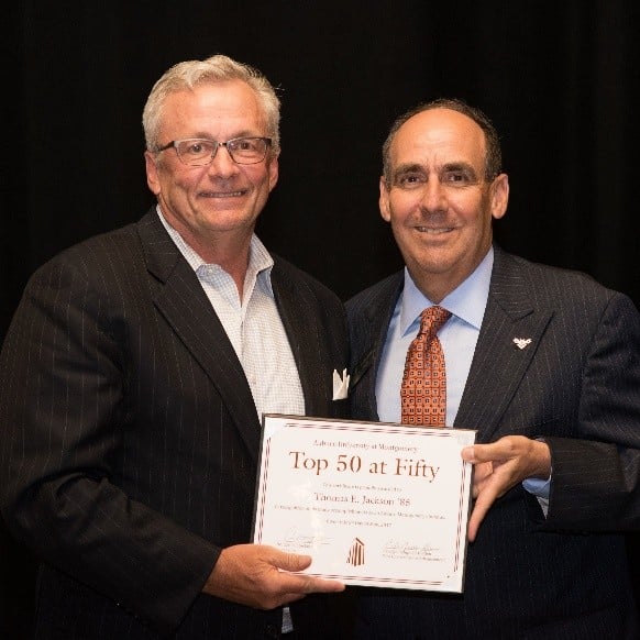 Tommy Jackson shows off at his award with Chancellor Stockton.