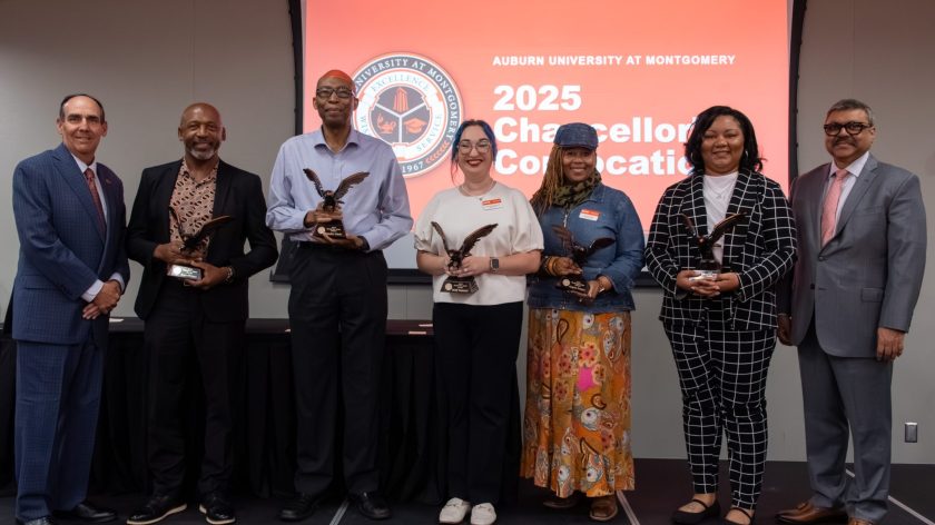 Auburn University At Montgomery 2025 Chancellor's Convocation Awardees Holding Eagle Statues On Stage.