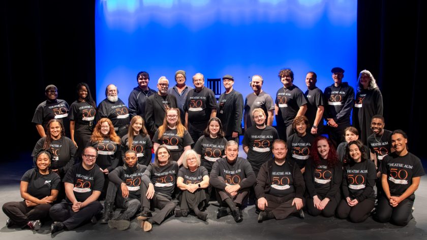 A Group Of People In Theatre AUM 50 Shirts On A Stage At Auburn University At Montgomery.
