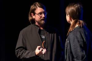 A Man And Woman Engage In Conversation On Stage At Auburn University At Montgomery Event.