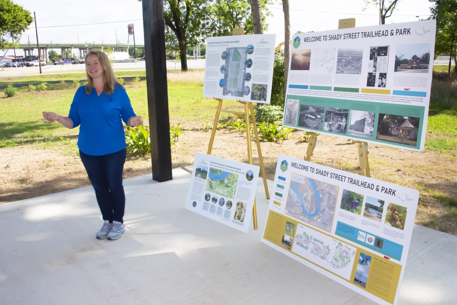 A person presenting informational posters at Shady Street Trailhead & Park, emphasizing community engagement.