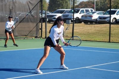 Auburn University at Montgomery women's tennis players in action on the court.