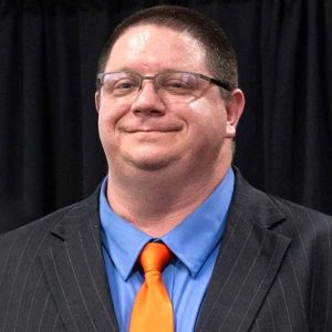 A Person In A Suit And Orange Tie At Auburn University At Montgomery Event.