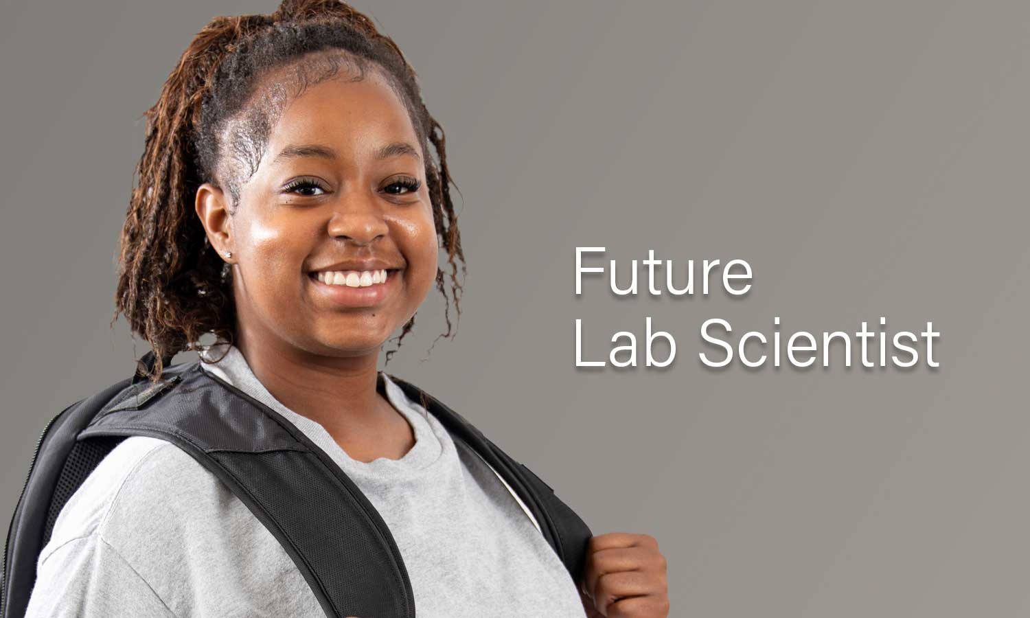 Auburn University at Montgomery student A'mya Rabb, future lab scientist on gray background