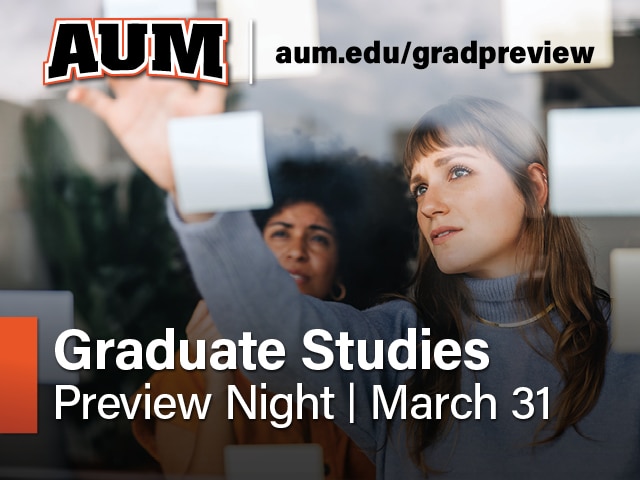 AUM Graduate Studies Preview Night on March 31; two students place notes on glass at Auburn University at Montgomery.
