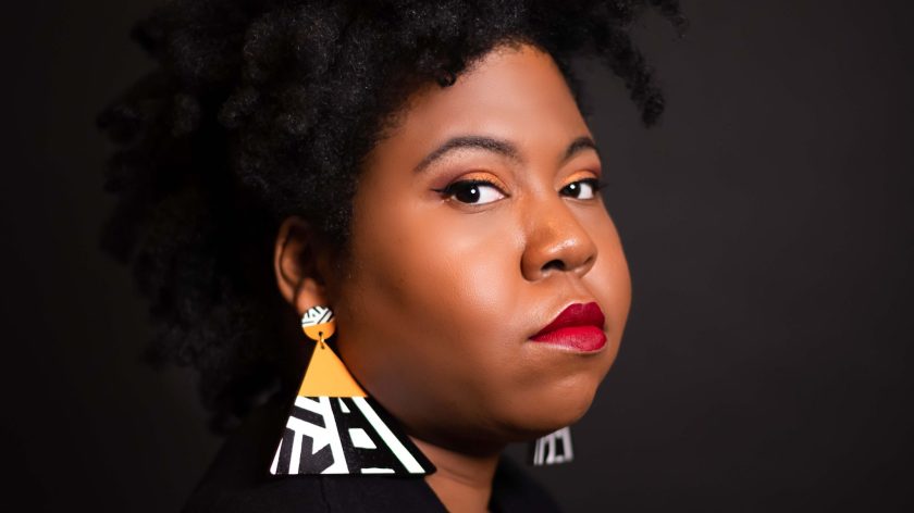 AUM Portrait Of A Woman With Natural Hair, Red Lipstick, And Bold Geometric Earrings At Auburn University At Montgomery
