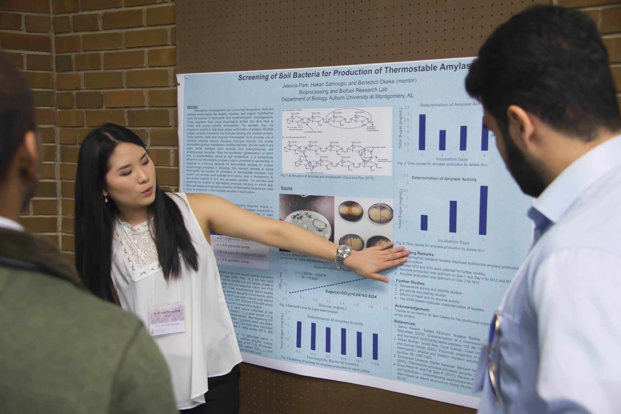 Auburn University at Montgomery student presents biology research poster on thermostable amylase to peers at symposium.