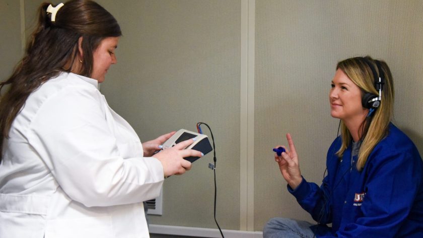 Auburn University At Montgomery Audiology Lab: A Technician Conducts A Hearing Test As A Person Responds Wearing Headphones