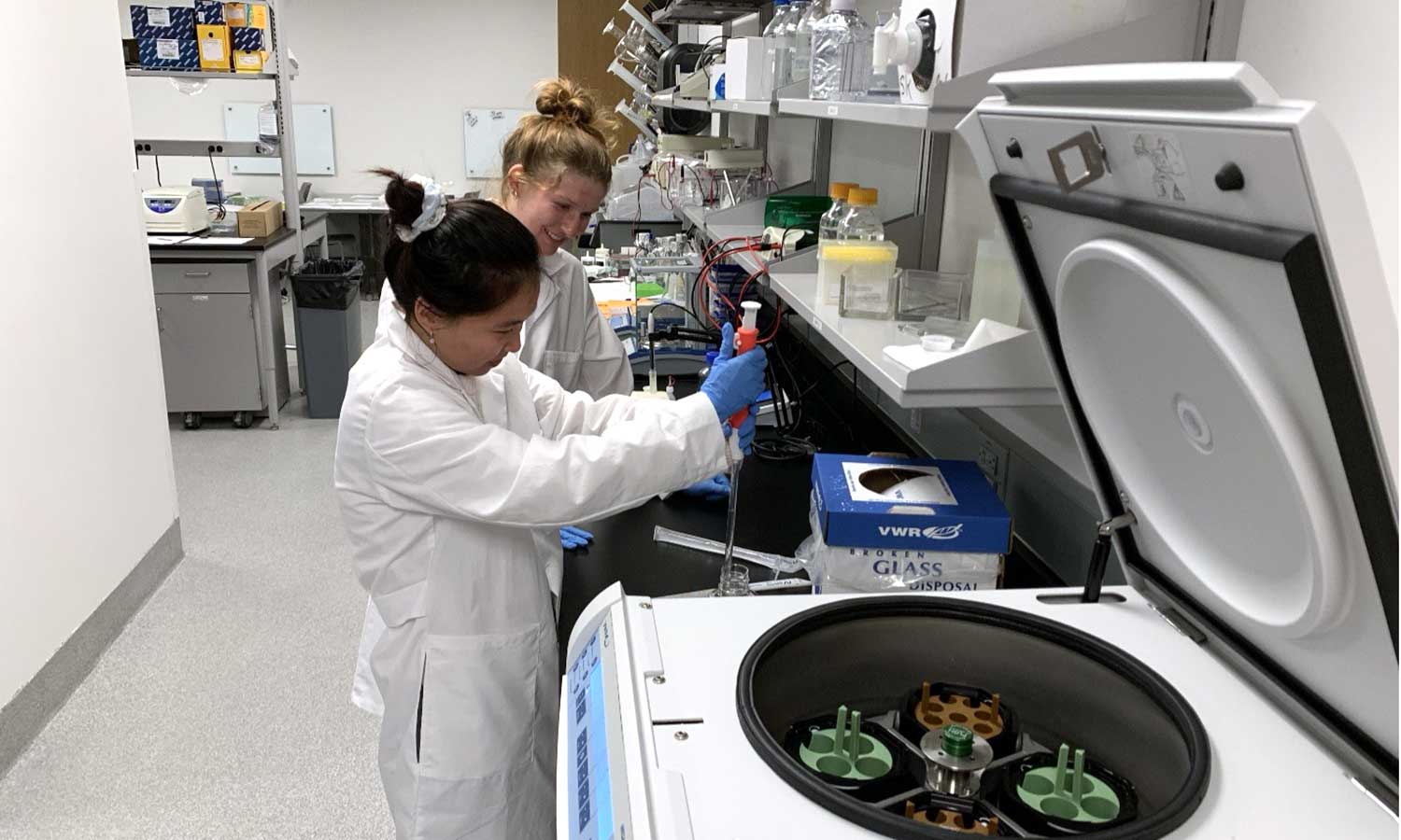 faculty-research-interests-chemistry Auburn University at Montgomery students use a pipette beside a centrifuge during biology research in a lab.